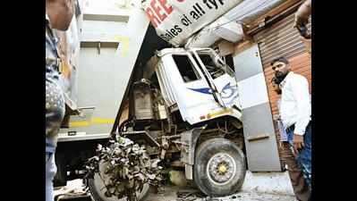 Sand-laden truck ploughs into closed shop, driver rescued