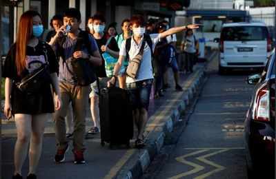 Bags packed, Malaysians stream into Singapore ahead of coronavirus travel ban