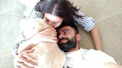 Virat Kohli and Anushka Sharma cuddle with their furry friend in this loved-up picture and it's adorable!