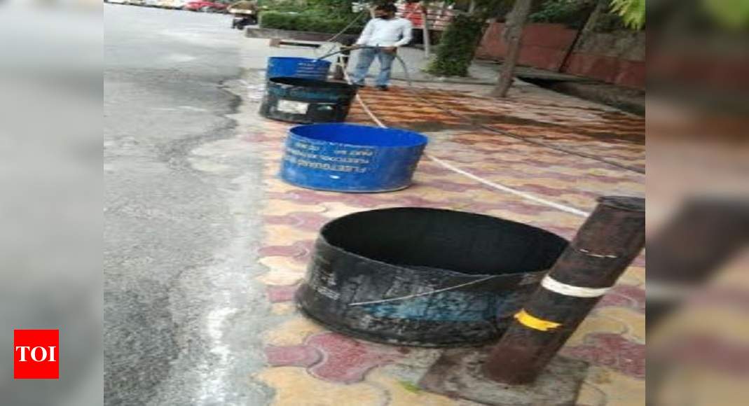 Noida residents provide roadside water in drums for stray cattle - Times of India