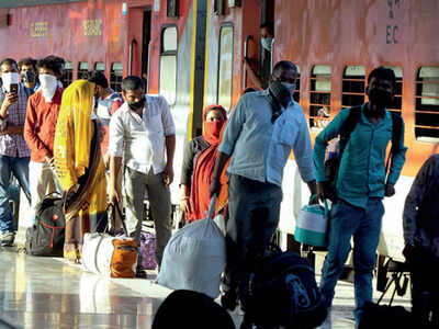 Migrants follow social distancing norms at a platform in Varanasi