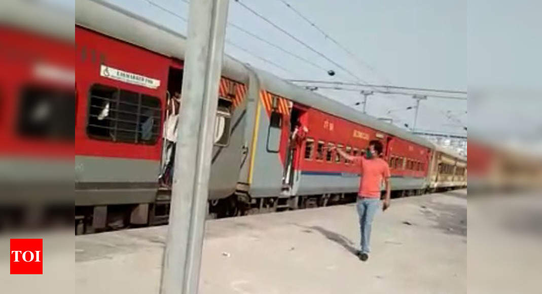 Up Railways Staffers Throw Biscuit Packs Towards Hungry Migrants