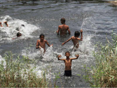 Boys take a bath in a canal to beat the heat, during the ongoing Covid-19 lockdown, in New Delhi on Saturday. (PTI photo)