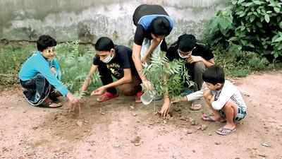 Volunteers tie red tape on trees, take pledge to save environment