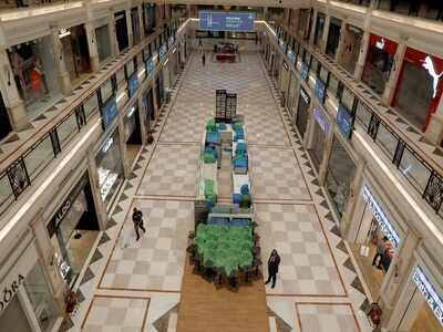 A worker cleans the floor of a shopping mall in Delhi (Reuters)