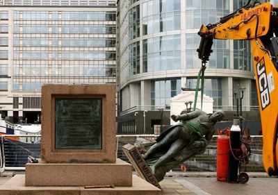Confronting a bygone era, London removes slave trader statue