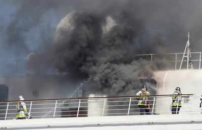 Black smoke billowing from cruise ship docked near Tokyo