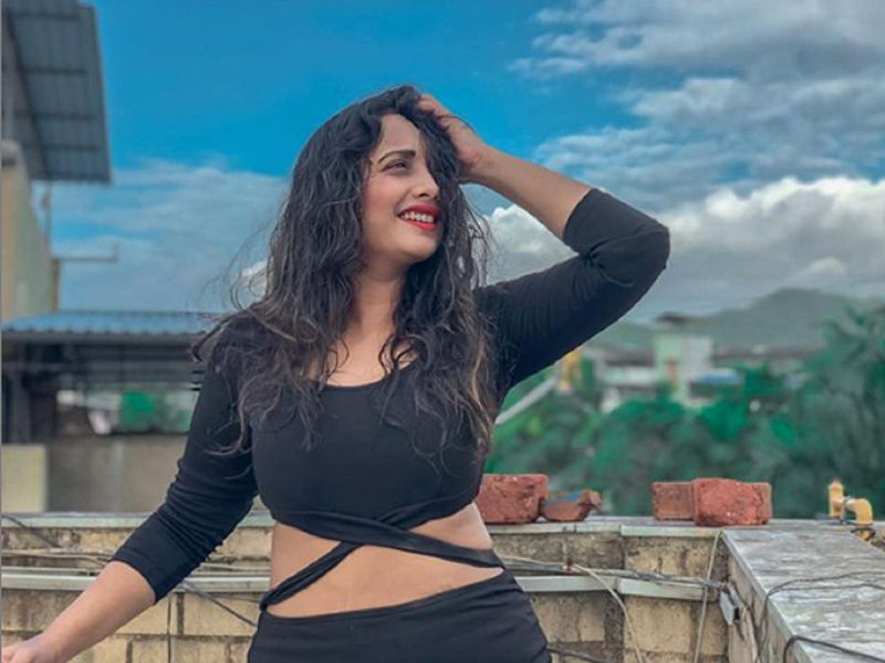 Rani Chatterjee looks stunning as she poses in a black bodycon outfit against the blue sky
