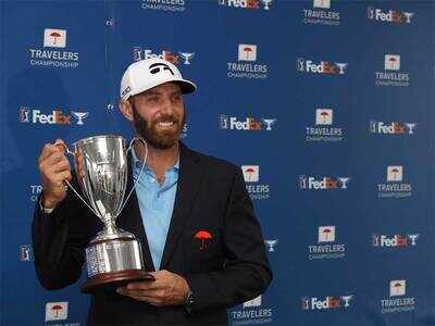 Dustin Johnson poses with the trophy (AFP Photo)