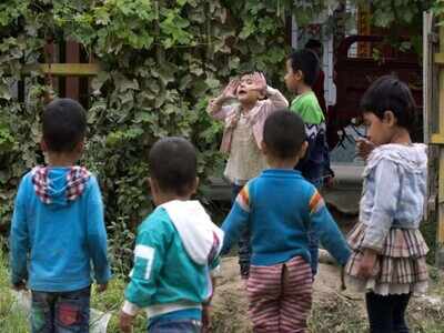 In this file photo, Uighur children play outdoors in Hotan in Western China's Xinjiang provience.