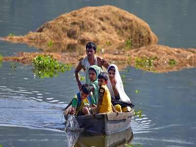 A family shifts to a safer place from flood-hit Baghmari village near Kaziranga