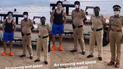 Varun Dhawan takes a stroll along Juhu beach wearing face mask as lockdown eases, says it's 'evening well spent' as he poses with Mumbai Police