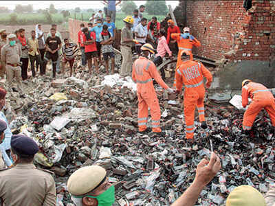 NDRF personnel go through the rubble at the explosion site in Modinagar on Sunday