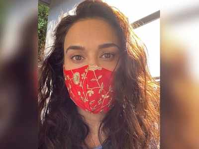 Preity Zinta poses with a designer mask; captions, "Desi vibe"