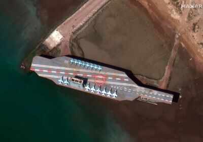 A satellite photo provided by Maxar Technologies shows a mockup aircraft carrier built by Iran is seen at Bandar Abbas, Iran, before being put to sea.