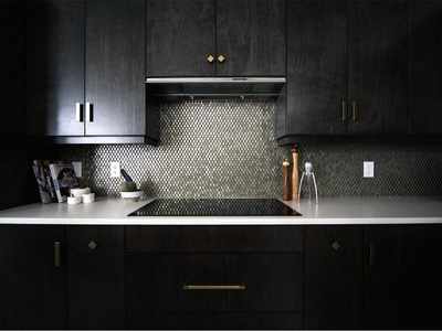 Add a pop of shine to kitchen cabinets with metallic hardware