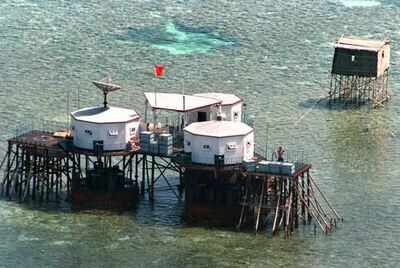 This file photo from 1995 shows China's flag flying over octagonal structures built on stilts at the Manila-claimed Mischief Reef in the disputed Spratly Islands (AFP)