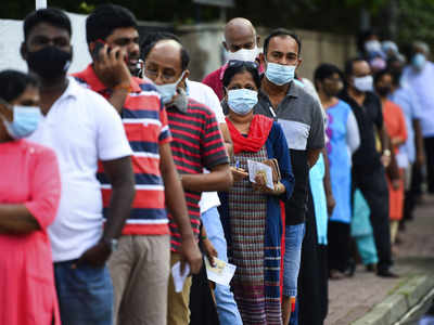 Sri Lankans, wearing masks, flock to voting centres for parliament election