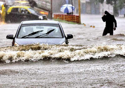 A car plods through a water-logged road at Bhendi Bazaar