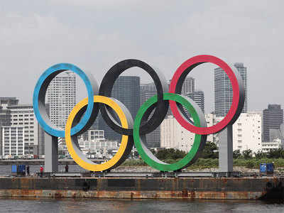 Giant Olympic rings in Tokyo towed away for maintenance