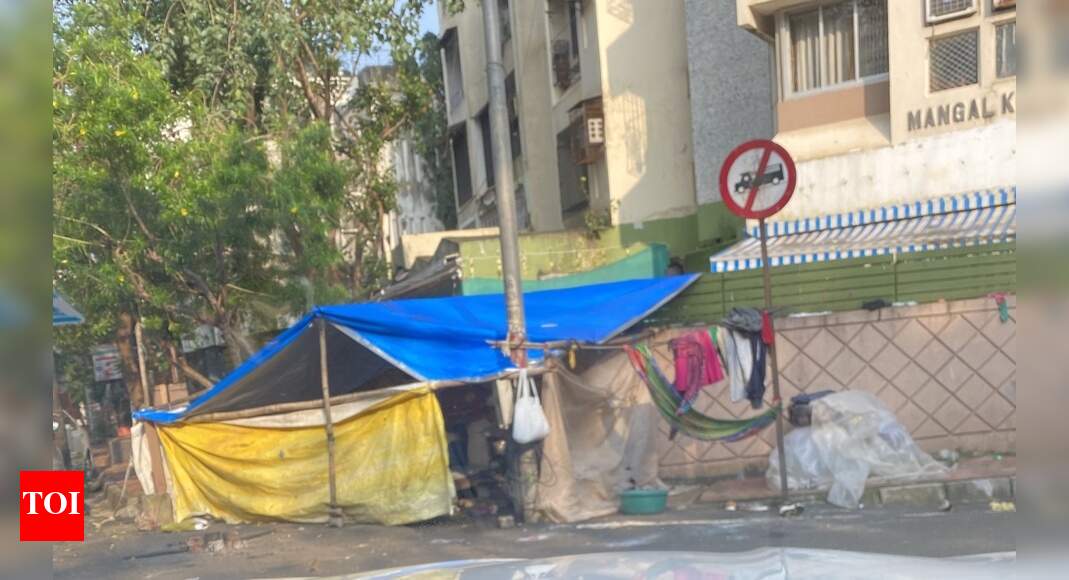 Footpath encroached - Times of India