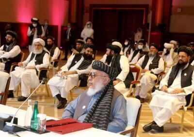 Taliban negotiator Abbas Stanikzai, right, with his delegation attends the opening session of the peace talks between the Afghan government and the Taliban in Doha, Qatar, Saturday, Sept. 12 (AP)