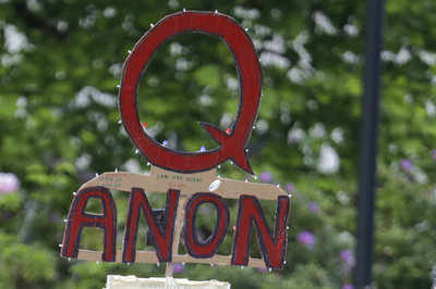 What is QAnon and how are social media sites taking action on it?