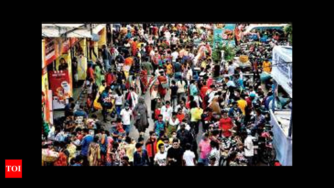 Kolkata, India. 22nd Mar, 2023. People walk on a busy street in Kolkata  while pants are being hanged above the street for drying purposes. (Credit  Image: © Dipayan Bose/SOPA Images via ZUMA