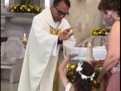 Funny video Priest raises hand to bless the girl she gives him