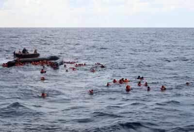 Refugees and migrants are rescued by members of the Spanish NGO Proactiva Open Arms, after leaving Libya trying to reach European soil aboard an overcrowded rubber boat in the Mediterranean sea, Wednesday, Nov. 11 (AP) At least 74 migrants dead in shipwreck off Libya coast, IOM says - Times of India