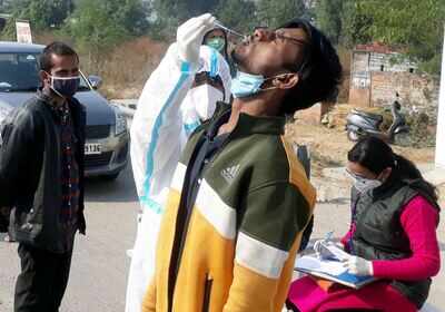 Medical staff collects swab sample from people coming from outside Kherki Daula toll plaza at Expressway, in Gurugram on Friday (ANI) 79331409