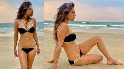 Nia Sharma looks ravishing in a black bikini with beautiful ornate lacework