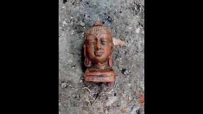 Buddha head, copper coins found in ancient mound