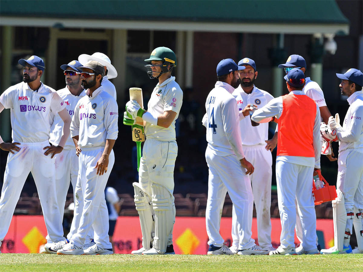India vs Australia: Paine joins Team India huddle, Langer calls him class  act after racism mars Sydney Test | Cricket News - Times of India