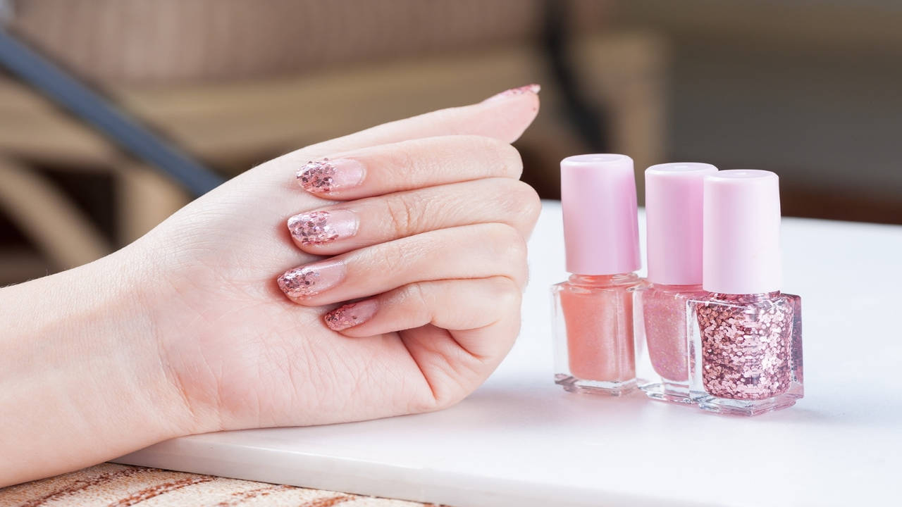 Blush pink nail polish and peony flowers