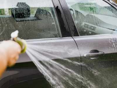 Car Wash from Spray Gun with Foam Aimed at the Car Wheel Stock