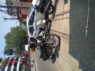 Two wheeler and cars parked at footpath