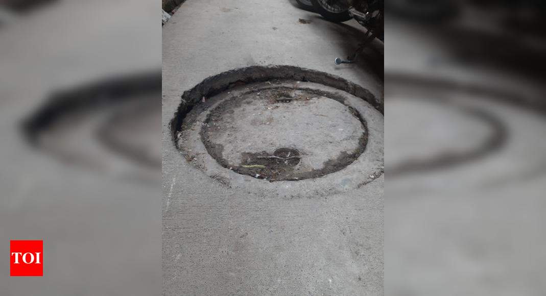 Manholes sunk, sewage overflows - Times of India