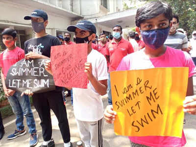 Swimmers with placards at the Karnataka Swimming Association office on Monday.