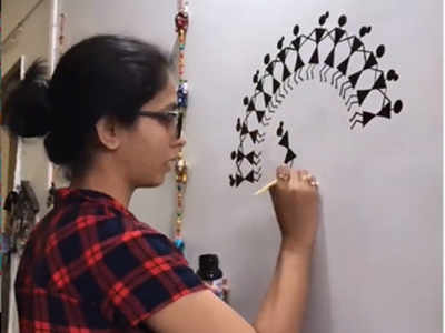 Sayali Sanjeev paints the wall of her house with 'Warli' art