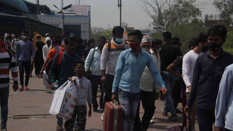 Delhi lockdown: Migrant workers throng Anand Vihar bus terminal to ...