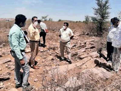 Officials from the ASI and mines & geology department survey the site