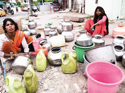 A woman sits near a dry tap in Jawahar Nagar on Monday