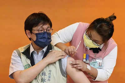 Taiwan raises coronavirus alert level after spike in infections
