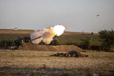 An Israeli artillery unit fires shells towards targets in Gaza Strip at the Israeli Gaza border (AP Photo)