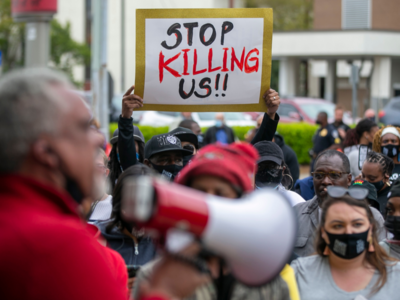 Black man's death fuels debate over police shooting at cars