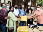 Bollywood actress Kajol distributes raincoats to BMC employees