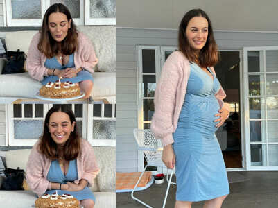 Evelyn flaunts her baby bump in a stylish dress