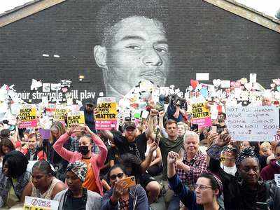 Demonstrators gather at vandalised mural of Marcus Rashford over England football racism