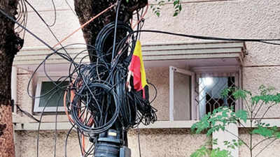 Bengaluru: Residents fume as dangling cables, wires on pavements pose danger